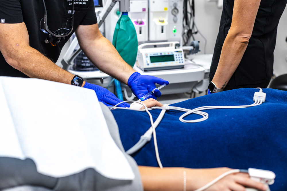 Dental team monitoring a patient during IV sedation