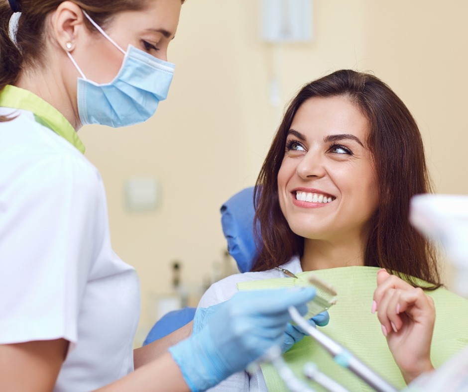 Patient smiling at her dentist before crown and bridge treatment