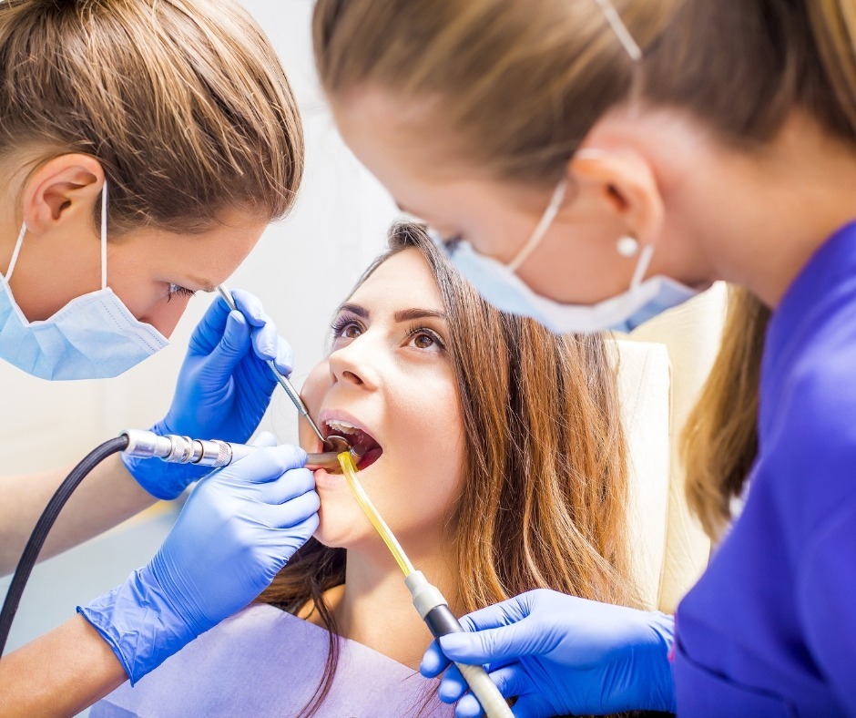 Dentist and assistant placing a filling for a patient